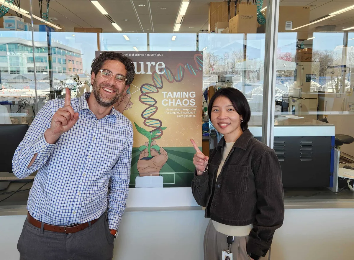 Two Spearhead Bio researchers holding the Nature issue featuring their work